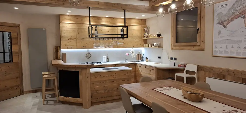 Wohnraum mit Weinregal, Sideboard und Wandverkleidung aus Altholz